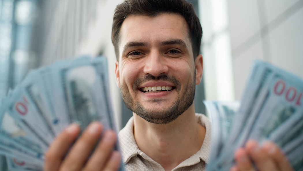 A customer celebrating a cash prize won from an insured Prop Card