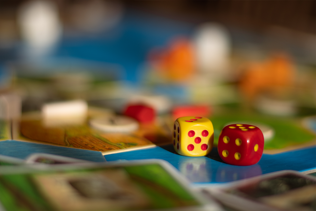 A pair of dice on a colorful game board
